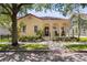Inviting single-story home featuring a lovely porch and well-manicured landscaping at 5038 Fenwood Ln, Orlando, FL 32814