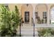 Inviting front porch with black rocking chairs and classic architectural details at 5038 Fenwood Ln, Orlando, FL 32814