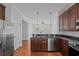 Open kitchen with stainless appliances, granite counters, and views to the living room at 5038 Fenwood Ln, Orlando, FL 32814
