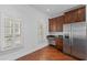 Bright kitchen area featuring stainless appliances, custom cabinets, and a built-in desk at 5038 Fenwood Ln, Orlando, FL 32814