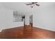 Spacious living room with hardwood floors flowing into the kitchen with granite countertops at 5038 Fenwood Ln, Orlando, FL 32814