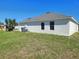 A view of the home's backyard shows the exterior stucco and window placement at 506 Peace Way, Kissimmee, FL 34759