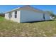 A side view of this home shows the modern stucco and ample yard space at 506 Peace Way, Kissimmee, FL 34759