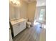 Bathroom featuring a white vanity, toilet, and shower-tub with a window at 506 Peace Way, Kissimmee, FL 34759