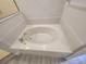 Bright bathroom featuring a large soaking tub with chrome fixtures and neutral colored tile at 506 Peace Way, Kissimmee, FL 34759