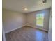 Bright bedroom featuring wood-look tile flooring and a window providing natural light at 506 Peace Way, Kissimmee, FL 34759