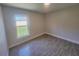 A basic bedroom with neutral walls and a window at 506 Peace Way, Kissimmee, FL 34759