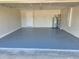 This spacious garage features a painted floor, water heater, and access door at 506 Peace Way, Kissimmee, FL 34759