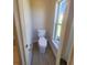 This is a clean half bathroom with a tiled floor and a bright window view at 506 Peace Way, Kissimmee, FL 34759