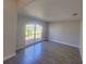 Neutral living room featuring tile flooring, a large window and light-colored walls at 506 Peace Way, Kissimmee, FL 34759