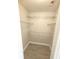 Walk-in closet with wire shelving and wood-look tile flooring at 506 Peace Way, Kissimmee, FL 34759