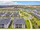 Picturesque aerial view showcasing the community's layout with homes, landscaped areas, and nearby pond at 507 Ocean Course Ave # 507, Davenport, FL 33896