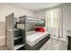 Bedroom featuring a bunk bed with stairs and red pillows on the bottom bunk at 507 Ocean Course Ave # 507, Davenport, FL 33896