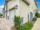 Townhome features a two-car garage, stone accents, landscape design and brick paved driveway at 507 Ocean Course Ave # 507, Davenport, FL 33896