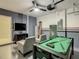 Finished garage featuring a pool table, comfortable seating and a wall mounted TV at 507 Ocean Course Ave # 507, Davenport, FL 33896