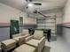Finished garage featuring a pool table, comfortable seating and epoxy flooring at 507 Ocean Course Ave # 507, Davenport, FL 33896