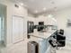 A stylish kitchen with white cabinetry, stainless steel appliances, island with bar seating, and pendant lighting at 507 Ocean Course Ave # 507, Davenport, FL 33896