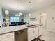 Kitchen island featuring modern fixtures, stainless steel appliances, and open layout looking into the living room at 507 Ocean Course Ave # 507, Davenport, FL 33896
