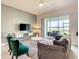 Comfortable living room with plush rug, TV, and access to outdoor patio at 507 Ocean Course Ave # 507, Davenport, FL 33896