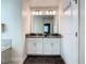 Main bathroom featuring double sinks, vanity and a view to the tub and shower at 507 Ocean Course Ave # 507, Davenport, FL 33896