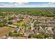 An aerial view of homes in a neighborhood with a pond in the distance at 528 Seven Oaks Blvd, Winter Springs, FL 32708