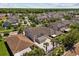 This aerial view captures the neighborhood, highlighting the home's location with manicured landscaping and a large paver patio at 528 Seven Oaks Blvd, Winter Springs, FL 32708