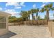 Wide backyard with brick pavers, a wooden pergola with swing, and lush palm trees along the fence at 528 Seven Oaks Blvd, Winter Springs, FL 32708