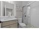 Stylish bathroom featuring dual sinks, quartz countertops, and a glass-enclosed shower at 528 Seven Oaks Blvd, Winter Springs, FL 32708