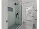 Modern bathroom featuring a glass-enclosed shower, sleek tile, and contemporary fixtures for a spa-like experience at 528 Seven Oaks Blvd, Winter Springs, FL 32708