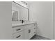 Modern bathroom featuring a sleek vanity with a black faucet and a large mirror at 528 Seven Oaks Blvd, Winter Springs, FL 32708