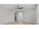 Bright, airy bedroom with a ceiling fan, hardwood floors, and a glimpse into the ensuite bathroom at 528 Seven Oaks Blvd, Winter Springs, FL 32708