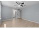This light-filled bedroom boasts hardwood floors and a ceiling fan, offering a comfortable retreat at 528 Seven Oaks Blvd, Winter Springs, FL 32708