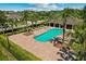 Enjoy the community pool with palm trees and lounge chairs, ideal for relaxing and soaking up the sun at 528 Seven Oaks Blvd, Winter Springs, FL 32708