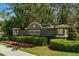 A stately brick entrance sign welcomes residents to the Seven Oaks community with lush landscaping at 528 Seven Oaks Blvd, Winter Springs, FL 32708