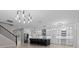 Open kitchen featuring a large island with seating, white cabinets, and stainless steel appliances at 528 Seven Oaks Blvd, Winter Springs, FL 32708