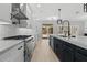 Stylish kitchen with white cabinets, stainless steel appliances, and a large island with a sink at 528 Seven Oaks Blvd, Winter Springs, FL 32708