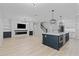 Spacious open-concept kitchen with island and modern finishes next to the Gathering room at 528 Seven Oaks Blvd, Winter Springs, FL 32708