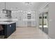 Modern kitchen with white cabinets, and a large island with seating and exterior view at 528 Seven Oaks Blvd, Winter Springs, FL 32708