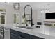 Modern kitchen features a large island with a white countertop and dark blue cabinets at 528 Seven Oaks Blvd, Winter Springs, FL 32708