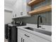 Well-equipped laundry room with modern appliances and ample counter space and sleek shelving at 528 Seven Oaks Blvd, Winter Springs, FL 32708