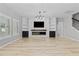Bright living room with a modern fireplace and built-in bookshelves at 528 Seven Oaks Blvd, Winter Springs, FL 32708