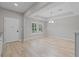 Bright, empty living room with hardwood floors and stylish recessed ceiling at 528 Seven Oaks Blvd, Winter Springs, FL 32708