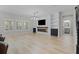 Open-concept living room with modern fireplace and large windows providing natural light at 528 Seven Oaks Blvd, Winter Springs, FL 32708