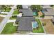 Aerial view of a home with a screened-in pool set in a neatly landscaped backyard at 6758 Hillis Dr, Lakeland, FL 33813