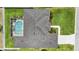 Aerial view of a home with a screened-in pool and well-maintained landscaping at 6758 Hillis Dr, Lakeland, FL 33813