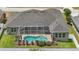 Overhead view of the home featuring a large roof, a screened-in pool, and lush landscaping at 6758 Hillis Dr, Lakeland, FL 33813