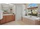 A bathroom featuring a garden tub, a linen closet, and a shower at 6758 Hillis Dr, Lakeland, FL 33813