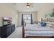 Bright bedroom with a ceiling fan, TV, large window and a view of the outdoors at 6758 Hillis Dr, Lakeland, FL 33813
