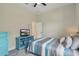 This carpeted bedroom with a ceiling fan, queen bed, and pastel decor offers a comfortable space at 6758 Hillis Dr, Lakeland, FL 33813