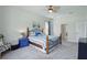 Comfortable bedroom featuring a metal bed frame, ceiling fan, and blue accents at 6758 Hillis Dr, Lakeland, FL 33813